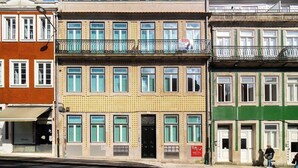 A multi-story building with a ground-floor shop and upper-floor apartments. - Modern Studio in Santa Catarina (Porto)