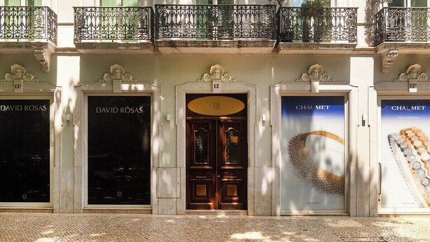 A building facade with three storefronts labeled 'DAVID ROSAS', 'DAVID ROSAS', and 'CHAUMET'. - Timeless Design Meets Central Convenience (Lisbon)