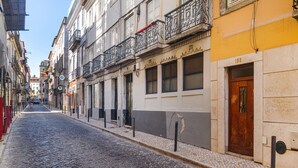 A cobblestone street lined with historic buildings, some with balconies and signage. - Live Like a Local in Vibrant Bairro Alto (Lisboa)