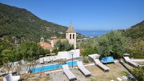 A hillside view with a church, a swimming pool, and lounge chairs. - Nice home in Gioiosa Marea (Gioiosa Marea)