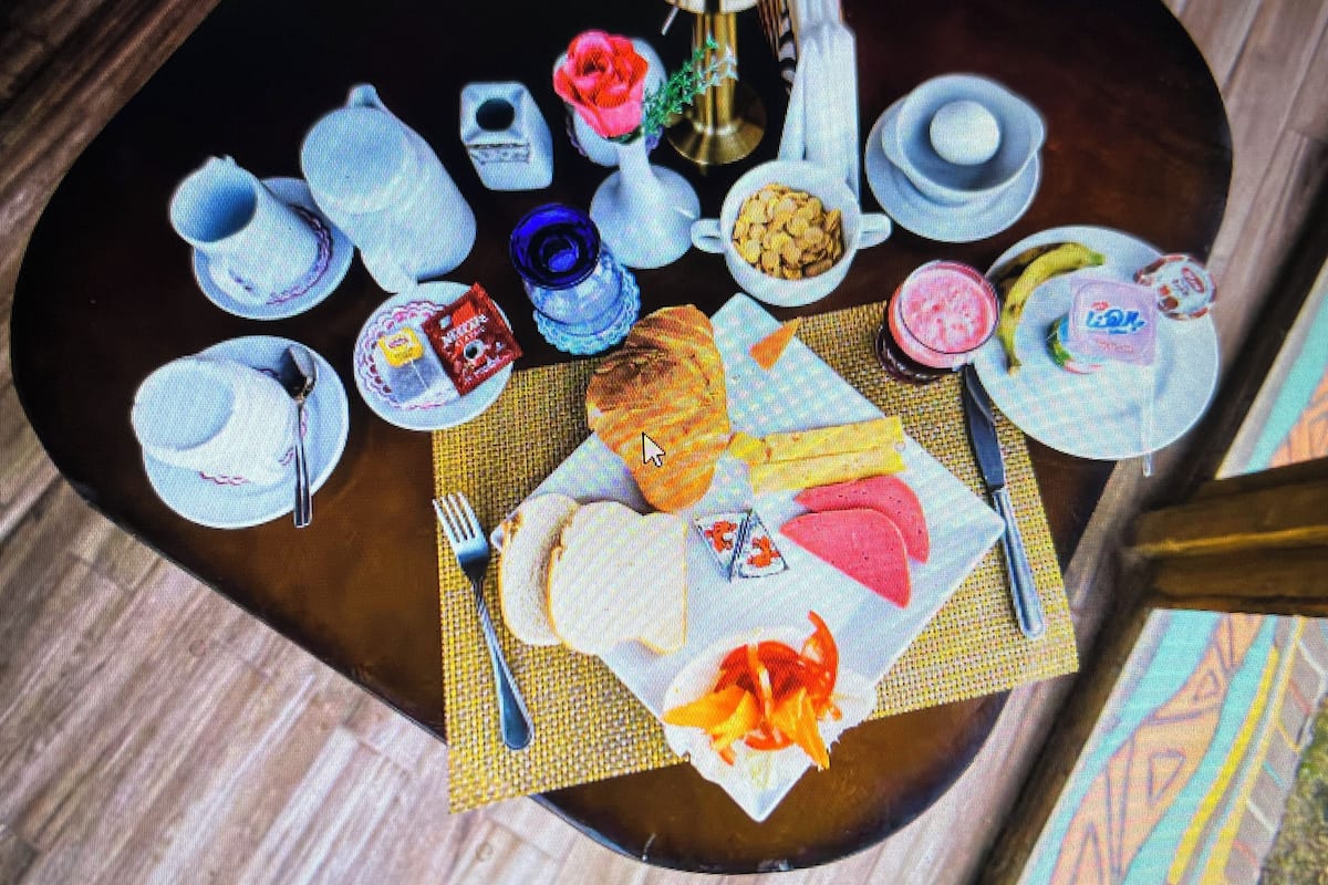 A dining table with various dishes, utensils, and a centerpiece.