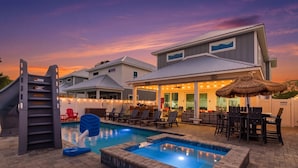 A pool area with lounge chairs, a hot tub, and a covered patio with string lights. - 5 Kings-Private Backyard Oasis, Pool/Spa/Turbo Slide-Beach (Panama City Beach)