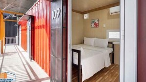A room with a bed, a window, and a door. - Nin Garden Homestay (Vung Tau)