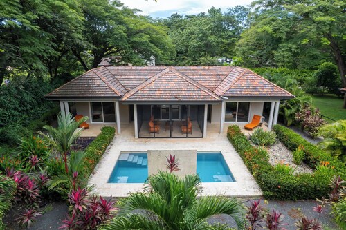 Beautiful Home in a Gated Neighborhood, Walking Distance to the Beach with Garden Views and a Pool