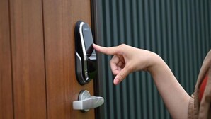 A hand pressing a modern door lock. - Toya Center Village (Toyako)