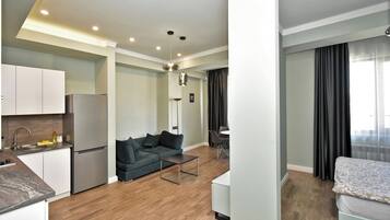Classic Apartment, Balcony, City View | Living area | 50-inch flat-screen TV with cable channels