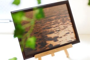 A framed artwork on a wooden easel. - S’CASA Nishishinjuku (Tokyo)