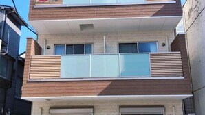 A modern multi-story residential building with a balcony on the second floor. - WANO (Osaka)