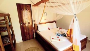 A bedroom with a wooden bed, a canopy, a wooden chair, a woven mat, and a door. - SuBanda Boutique Hotel (Makunduchi)