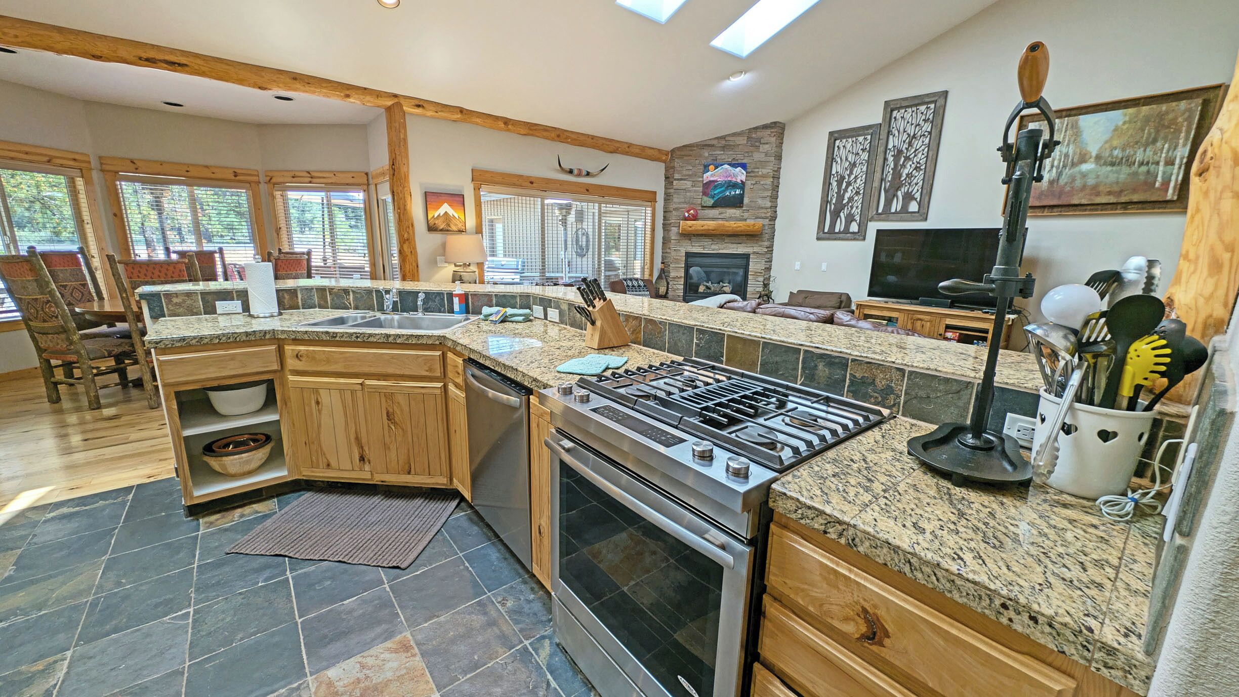 A spacious kitchen with granite countertops, a built-in oven, and a large island.
