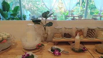 A breakfast buffet with various food items and a decorative centerpiece.