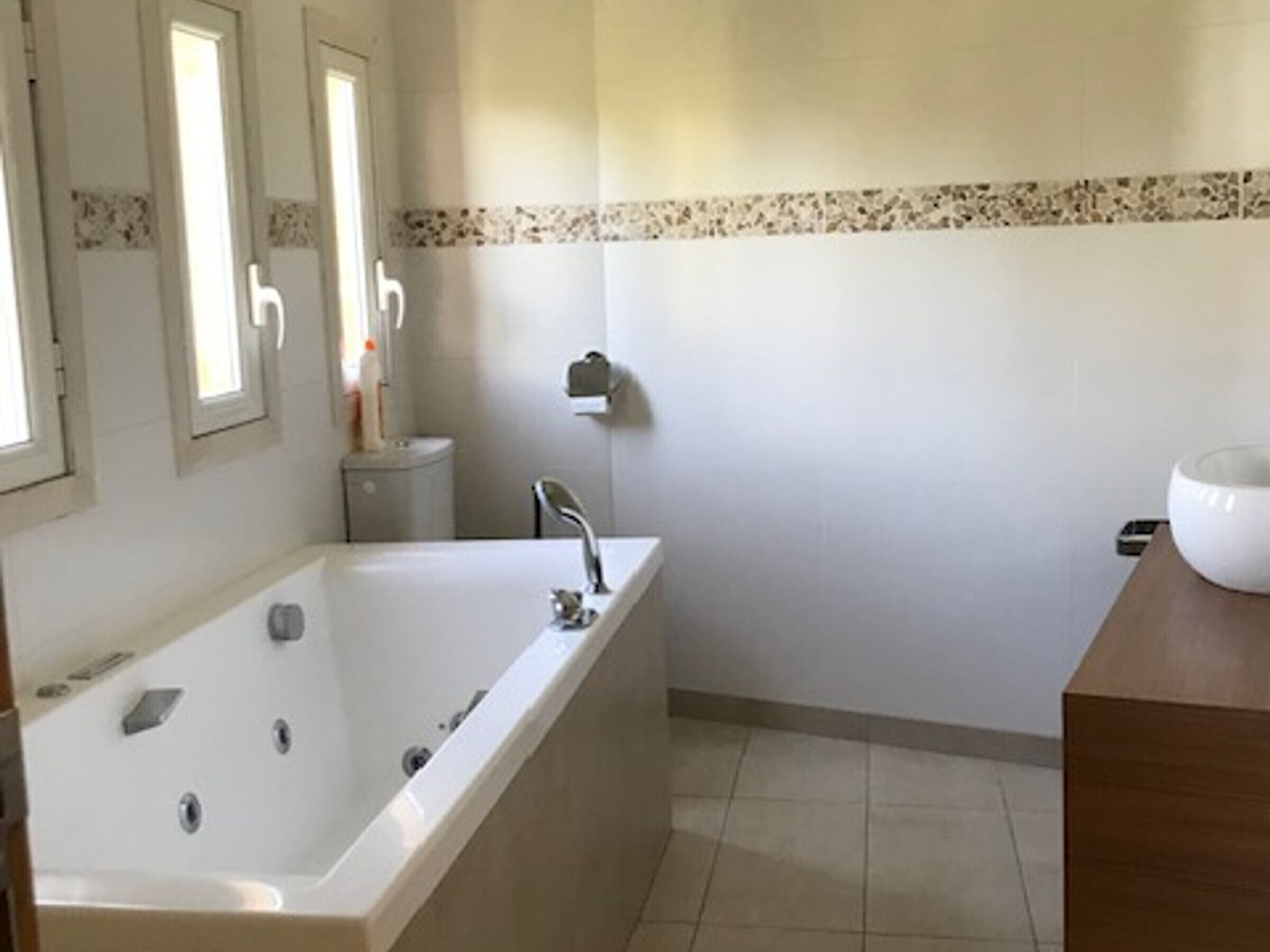 A bathroom with a bathtub, a sink, and a toilet.