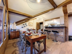 A dining area with wooden furniture, a wooden ceiling, and a kitchen area with a wooden counter. - Spacious apartment 6 pers. · Near slopes · Balcony · WIFI (Saint-Martin-de-Belleville-Les Menuires)