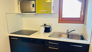 A compact kitchen with a microwave, toaster, and sink. - Bright 3-room apartment with parking in Serre Chevalier (Serre Chevalier Chantemerle)