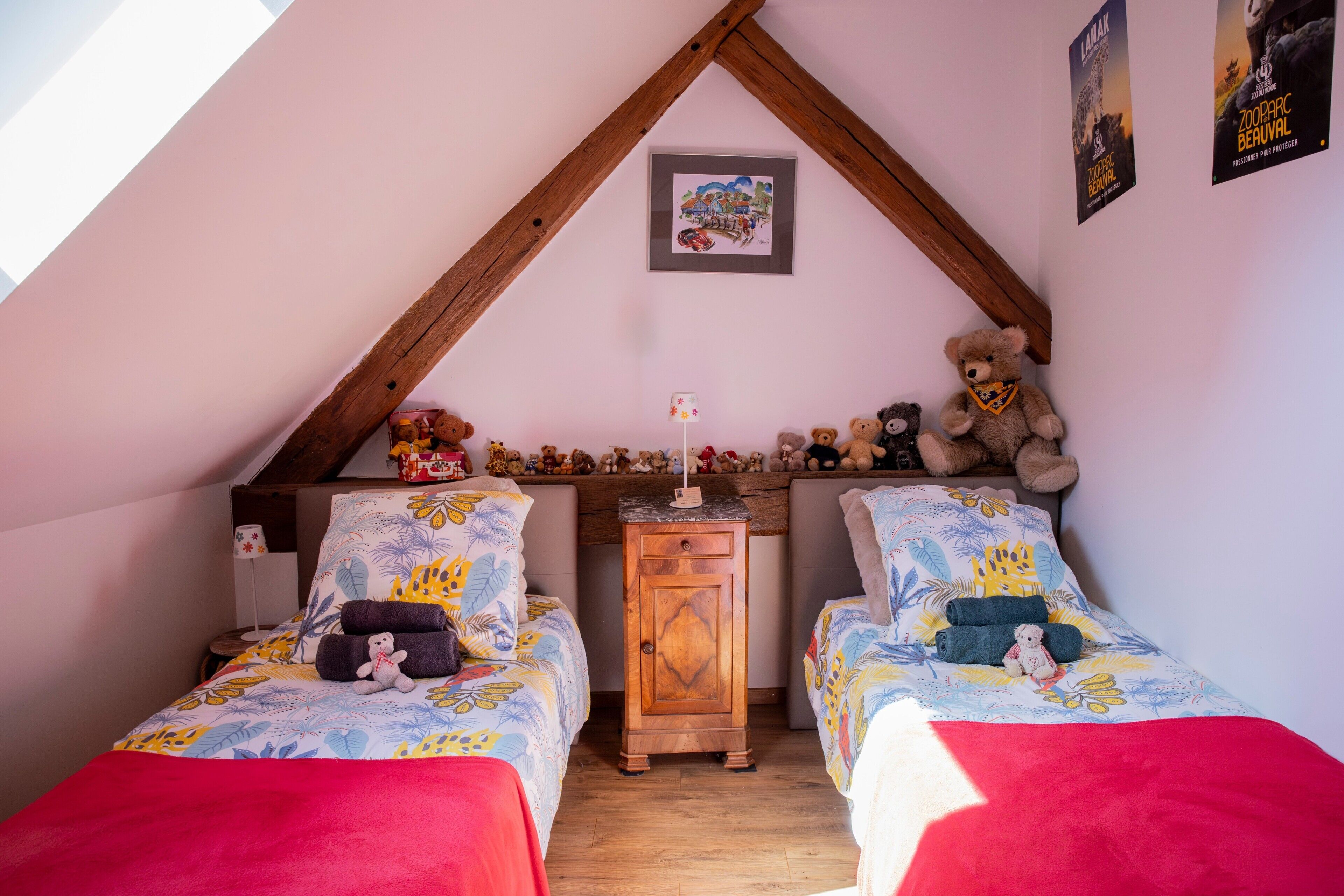 Un dormitorio con dos camas, un aparador de madera y un oso de peluche.