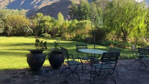 A patio with outdoor seating, a lawn, and a mountain view. - w Peaceful 4BR Villa With Nature View (Pisac)