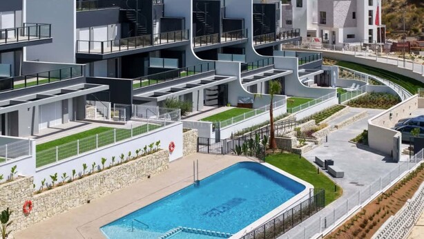 A modern hotel with multiple balconies, a swimming pool, and a view of the sea. - Residencial Breeze 1A by Bookaparadise (Finestrat)