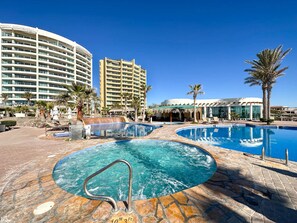 A resort with a large swimming pool, a spa area, and a building with multiple balconies. - Waves Relaxation Oceanfront 2BR Family Condo (Puerto Peñasco)