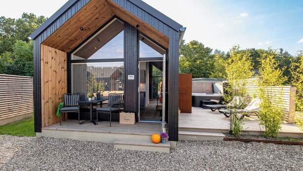 A modern, two-story building with a wooden exterior and large glass windows. - Ribe Camping (Ribe)