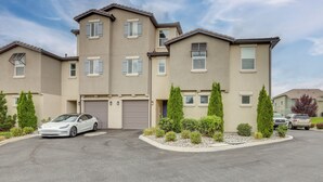 A multi-story residential building with a garage, a driveway, and a parking area. - Home Base w/ Easy 1-80 Access: 4 Mi to Dtwn Reno! (Reno)
