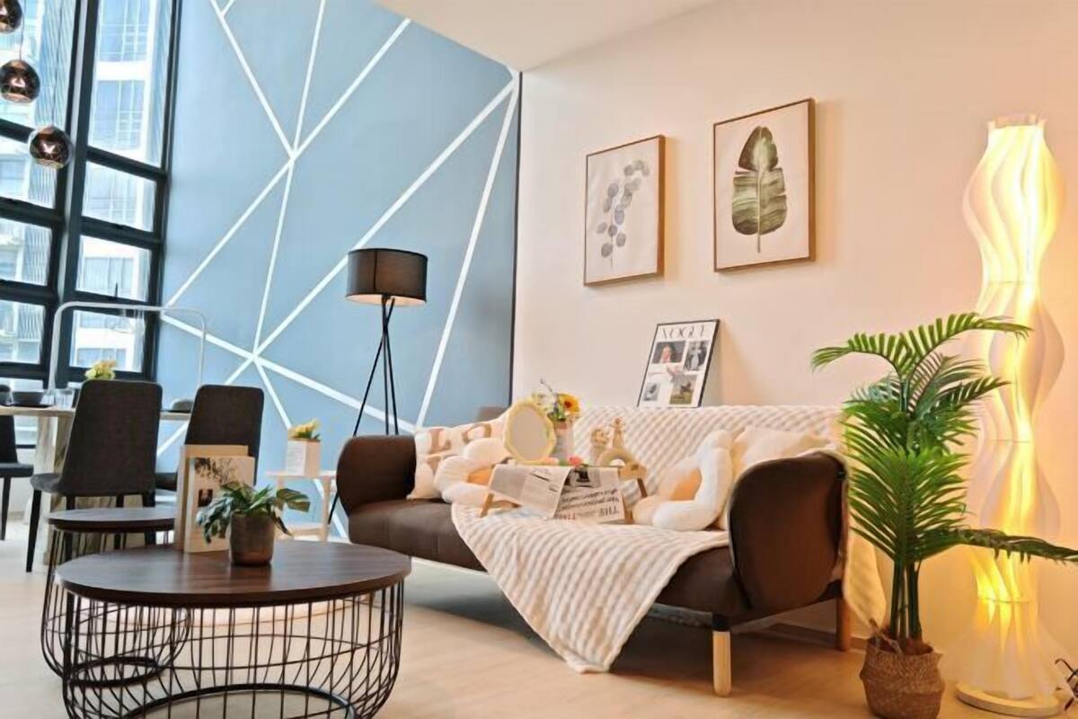 A modern living room with a sofa, a round coffee table, and a floor lamp.