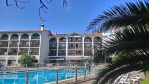 Seasonal outdoor pool, open 9:00 AM to 8:00 PM, pool umbrellas