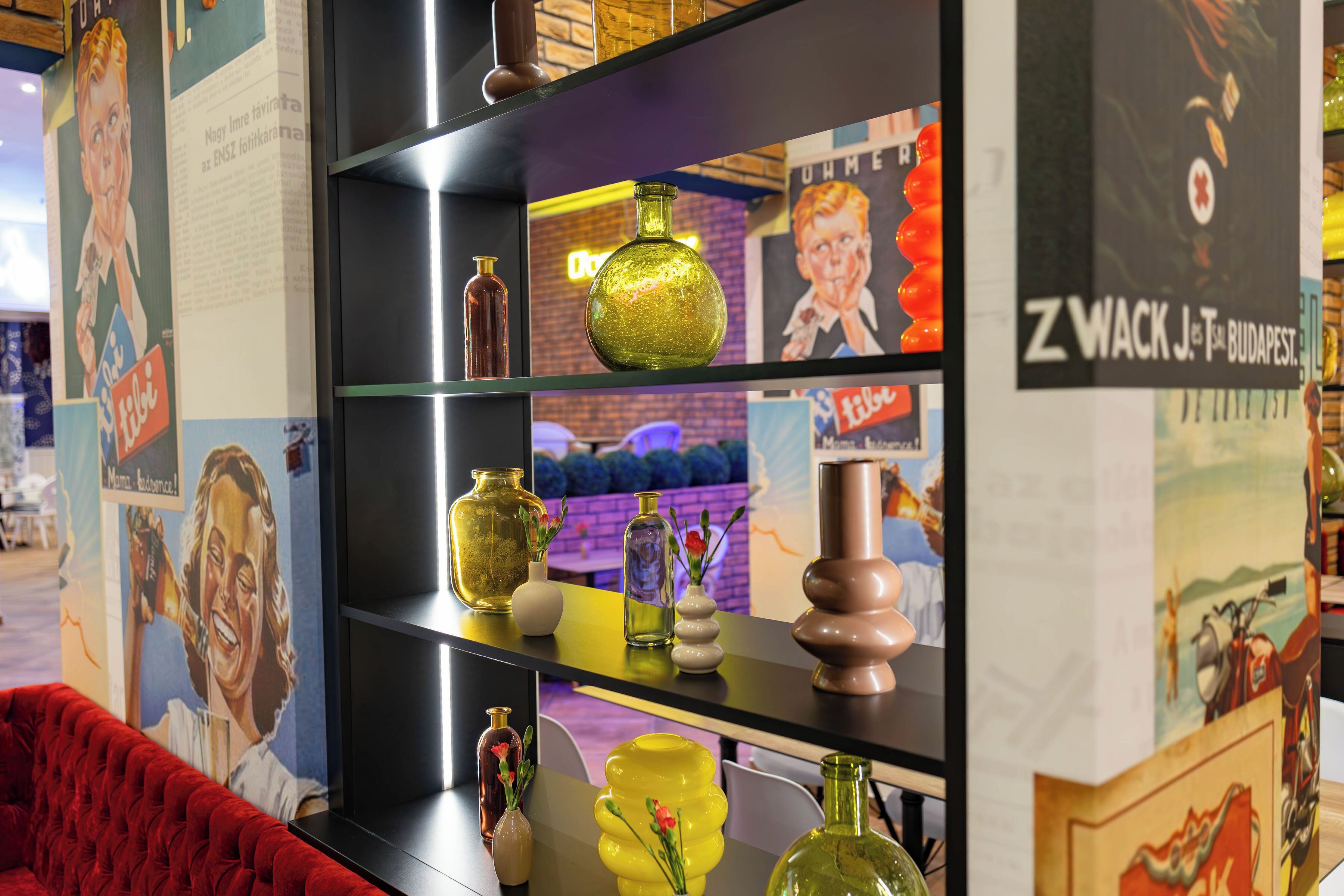A shelf with various glass vases and decorative items.