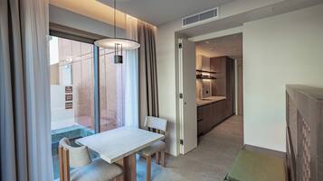 Luxury Studio, Pool View | Living area | TV, heated floors