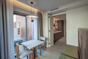 Luxury Studio, Pool View | Living area | TV, heated floors