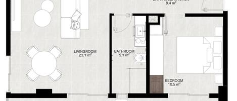 A floor plan of a hotel room with a living room, balcony, bedroom, bathroom, and entrance/kitchen.
