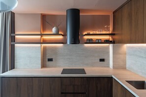 Superior Apartment, Garden View | Private kitchen | Stovetop, dishwasher, cookware/dishes/utensils, dining tables