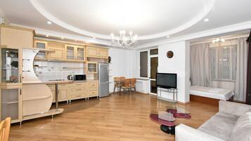 Apartamento, várias camas, sacada | Área de estar | TV de tela plana 50 polegadas com canais a cabo