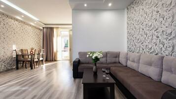 Comfort Apartment, Balcony, City View | Living area | 50-inch flat-screen TV with cable channels