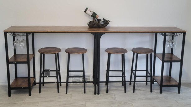 A bar area with a long wooden table and four stools. - Ridgeline #1 Unique 2 bedroom house in Helper. (Helper)