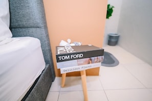 A stack of books titled 'Tom Ford' on a small wooden stool in a hotel room. - Swing & Pillows at Penang Road, Georgetown (Northeast Penang Island)