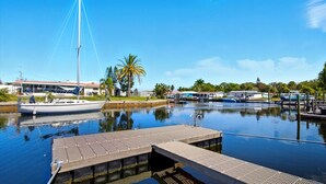 A marina with a dock, calm water, and boats. - Waterfront Retreat W / Floating Dock & Kayaks (New Port Richey)
