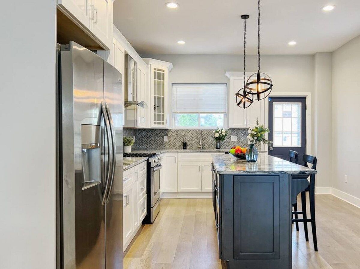 Full kitchen on the first floor with stove, oven, microwave, refrigerator, coffee maker, and other cooking essentials