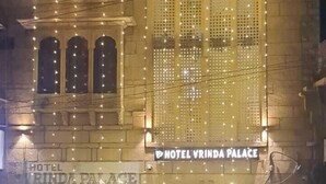 Hotel Vrinda Palace con luces colgantes, un letrero para un restaurante y un spa.
