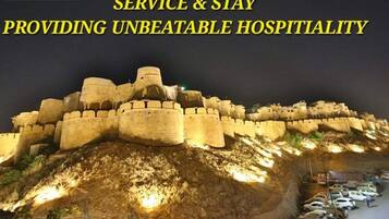 A fortified structure with a hotel sign, indicating a location with historical significance and modern amenities.