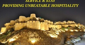 A fortified structure with a hotel sign, indicating a location with historical significance and modern amenities. - Hotel vrinda palace  (Jaisalmer)