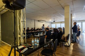 A conference room with a stage, tables, chairs, and a projector screen. - Blue Tree Towers Sorriso (Sorriso)