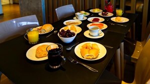 A breakfast table set with various dishes, including croissants, a bowl of fruit, and a cup of coffee. - Blue Tree Towers Sorriso (Sorriso)