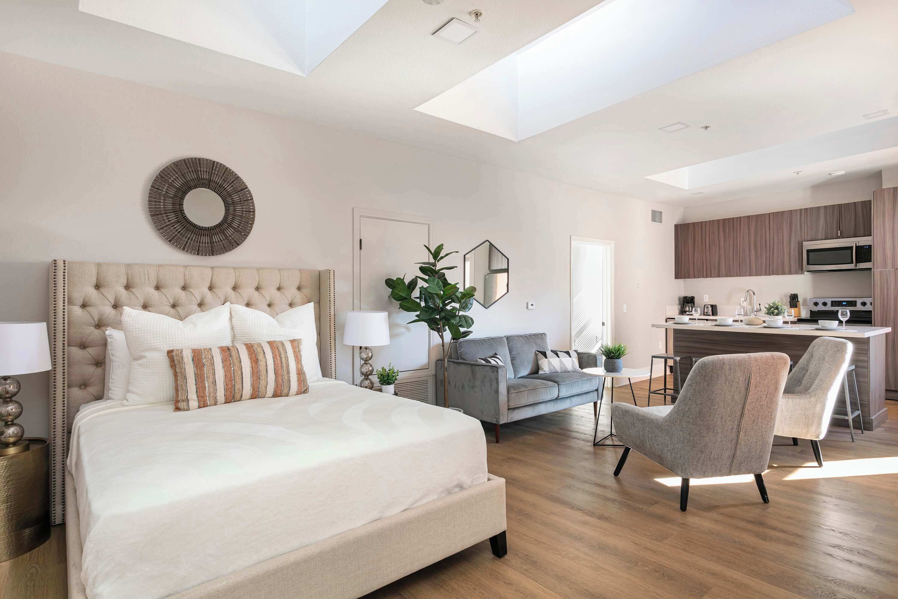 Un dormitorio moderno con una cama grande, un sofá y un comedor.