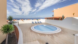 A rooftop pool with a clear view of the ocean, surrounded by lounge chairs and potted plants. - Vacation Apartment 'Ocean View Costa Adeje' with Sea View, Private Terrace and Wi-Fi (Costa Adeje)