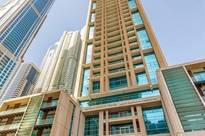 A high-rise building with multiple floors, large windows, and a modern architectural design. - Marina Hotel Apartments (Dubai)