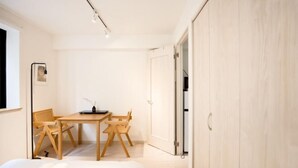A minimalist bedroom with a bed, a wooden desk, and a chair. - Calm Riverside Inn/Close to Ikebukuro (Tokyo)