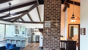 A spacious kitchen with modern appliances, a bar area, and a sign reading "Welcome to the Treehouse." - Archer's Perch -Incredible view - Right along the Blue Ridge Parkway (Hillsville)