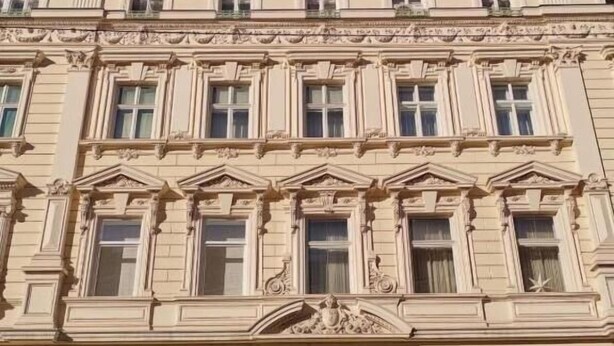 A classical building with ornate architectural details, large windows, and a storefront with a visible sign. - Deluxe Apartments Ria (Zagreb)