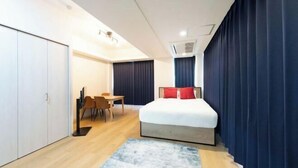 A modern hotel room with a bed, a desk, and a chair. - Fujiterrace Yoga (Tokyo)