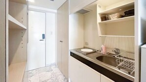 A modern bathroom with a sink, mirror, and storage cabinets. - Fujiterrace Yoga (Tokyo)